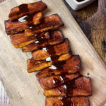 overhead shot of baked bbq tofu on wood platter