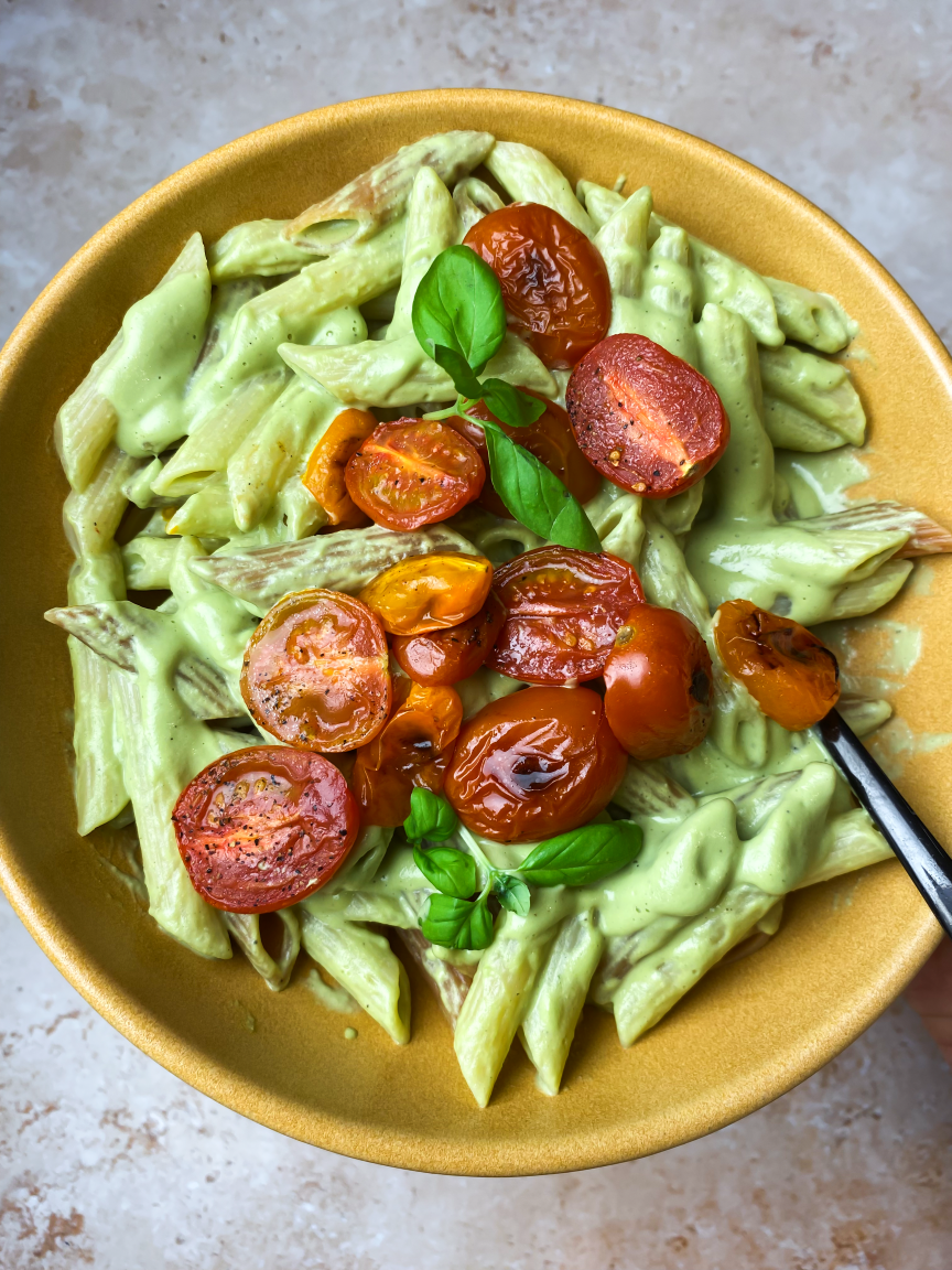 closeup of bowl of basil pasta with tomatoes