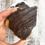 hand holding piece of cookie dough bark