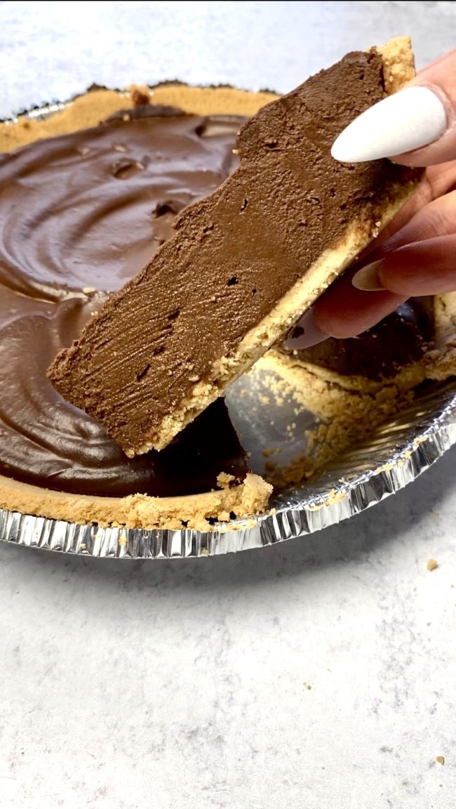 hand holding slice of pie