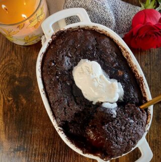 overhead shot of baked chocolate pudding cake with vegan whipped cream