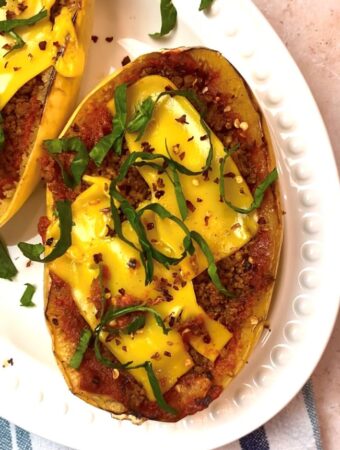 overhead shot spaghetti squash on white platter with toppings