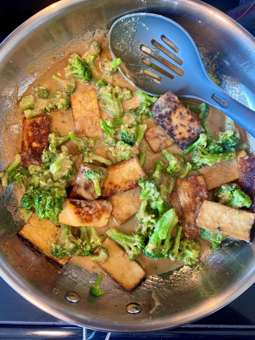 overhead shot of tofu and broccoli cooking in pan